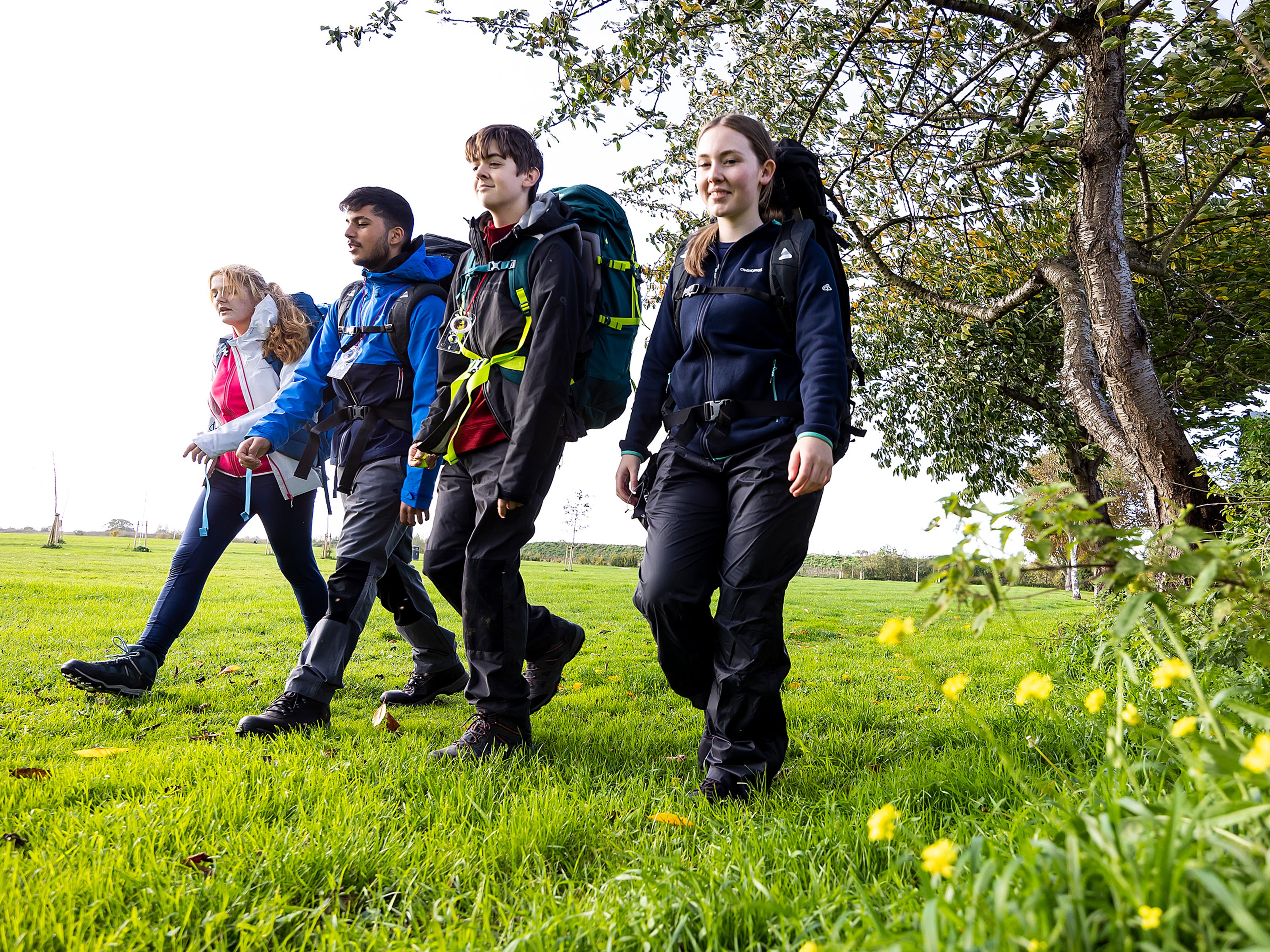 Children hiking through a field